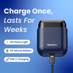 Nateskin electric shaver in a dark navy blue protective case, shown with a USB-C cable plugged in against a blue gradient background. The image includes marketing text highlighting features like LED status light, 60-minute battery, and USB-C charging.